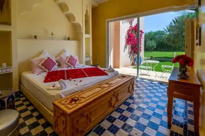 a bedroom with a large bed with a large window at Palais pyar in Najem