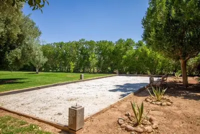a park with a bench in the middle of a field at Palais pyar in Najem