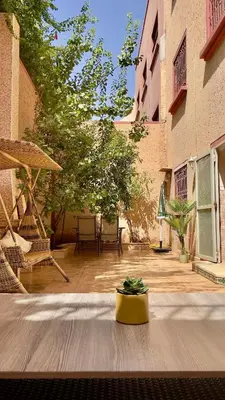 a courtyard with a yellow pot on a wooden floor at Marrakech Villa Floor Private Garden & Sport Space in Oulad Akkou
