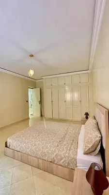 a bedroom with a large bed with white cabinets at Marrakech Villa Floor Private Garden & Sport Space in Oulad Akkou