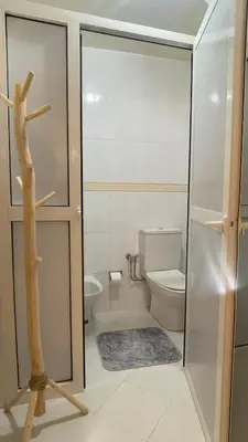 a bathroom with a toilet and a glass door at Marrakech Villa Floor Private Garden & Sport Space in Oulad Akkou
