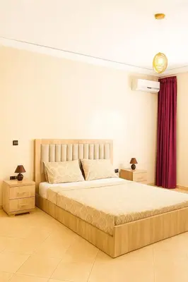 a bedroom with a large bed and two night stands at Marrakech Villa Floor Private Garden & Sport Space in Oulad Akkou