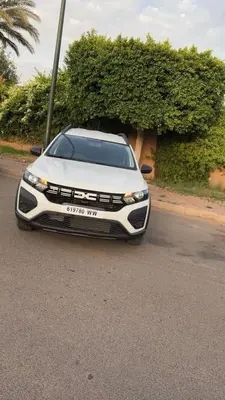 a white car parked on the side of a road at Bourgui Cars in Oulad Akkou