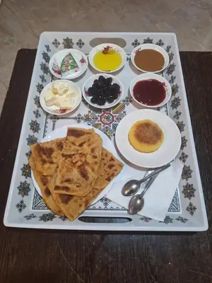 a tray of food with pita bread and other foods at Café nour dar ait ben haddou in Taskoukte