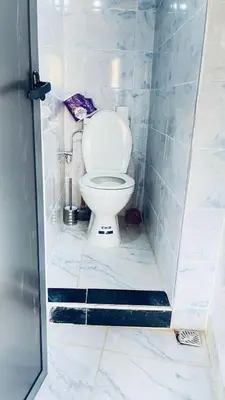 a bathroom with a white toilet in a stall at Chez Mazgiti in Ourika