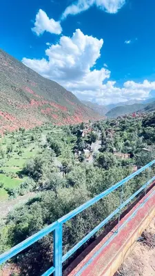 a view of a valley with a blue railing at Chez Mazgiti in Ourika