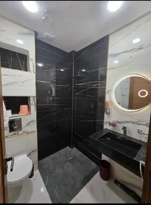 a bathroom with a sink and a toilet and a mirror at Appartement luxe 3 in Khenifra