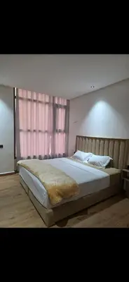 a large bed in a bedroom with a window at Appartement luxe 3 in Khenifra