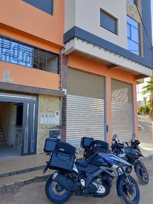 a motorcycle parked in front of a building at Appartement luxe 3 in Khenifra