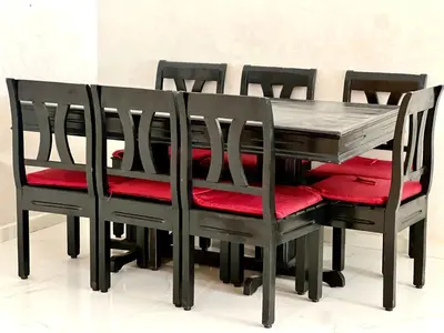a dining room table with four chairs and red cushions at Luxury Apartment - Fes Medina in Fès