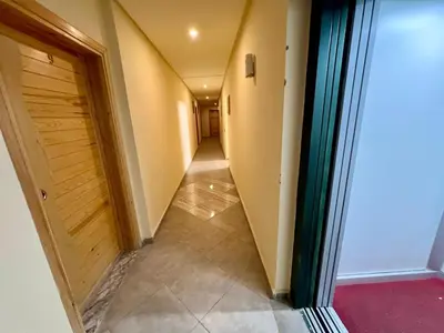 a long hallway with a door and a tile floor at Luxury Apartment - Fes Medina in Fès