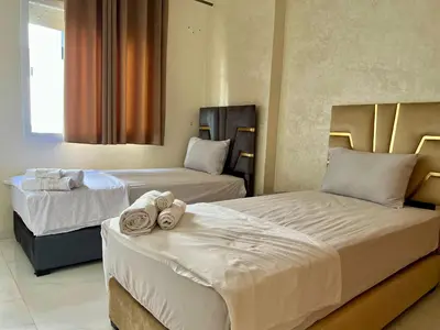 two beds in a hotel room with towels on them at Luxury Apartment - Fes Medina in Fès