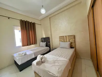 a bedroom with two beds and a window at Luxury Apartment - Fes Medina in Fès