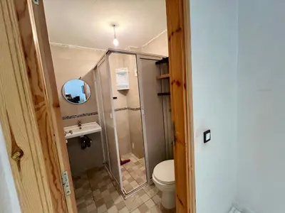 a small bathroom with a toilet and a shower at Luxury Apartment - Fes Medina in Fès