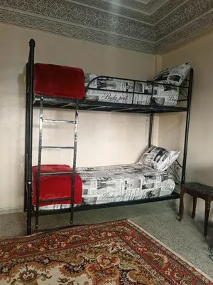 two bunk beds in a room with a carpet at KASBAH Guests Travel in Fès