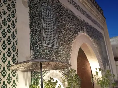 an umbrella sitting in front of a building at KASBAH Guests Travel in Fès