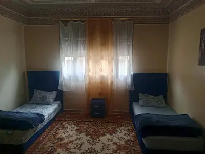 a room with two beds and a window at KASBAH Guests Travel in Fès