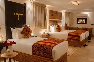 a hotel room with two beds and a couch at Riad Joy in Fès