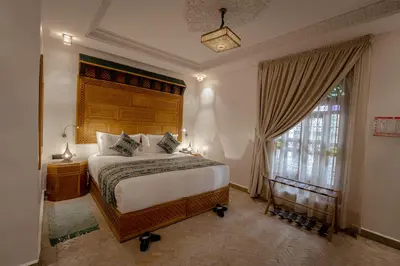 a bedroom with a large bed and a window at Riad Joy in Fès