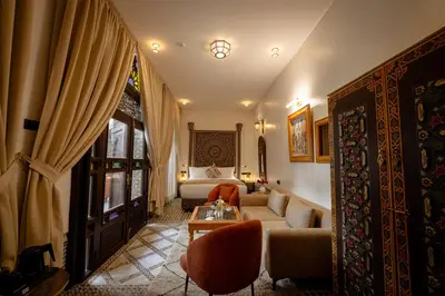 a living room with a couch and a table at Riad Joy in Fès