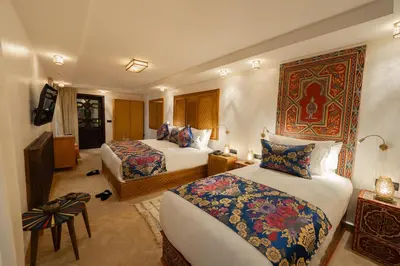 a hotel room with two beds in a room at Riad Joy in Fès