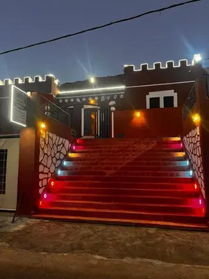a set of red stairs with lights in front of a building at Auberge Touristique Toubkal in Imlil