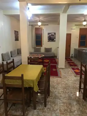 a living room with a table and a couch at Auberge Touristique Toubkal in Imlil