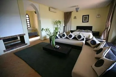 a living room with a bed and a couch at dar Jellouna Zaraba in Oulad Akkou
