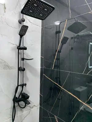 a shower in a bathroom with a black at Luxueux - Vue sublime - Fes City Center - à 2 min du parc de champs de course in Fès