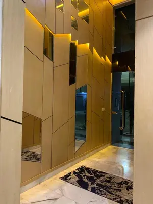 a lobby with a wooden wall with a mirror at Luxueux - Vue sublime - Fes City Center - à 2 min du parc de champs de course in Fès