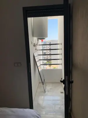 a view of a room with a bed and a window at Luxueux - Vue sublime - Fes City Center - à 2 min du parc de champs de course in Fès