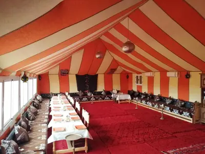 a large room with tables and chairs in it at Bivouac Luxe Masandoia Meteorites in Lac Yasmins