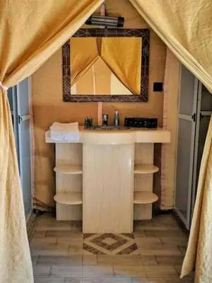 a bathroom with a sink and a mirror at Honeymoon Luxury Camp in Merzouga