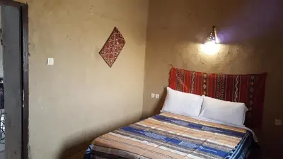 a bedroom with a bed in a room at Secret du Sahara in Merzouga