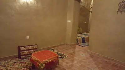 an empty room with a room with two beds at Secret du Sahara in Merzouga