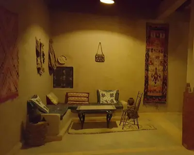 a living room with a couch and a table at Secret du Sahara in Merzouga