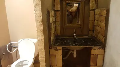 a bathroom with a sink and a toilet at Secret du Sahara in Merzouga