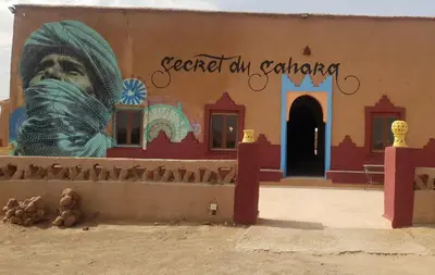 a building with a mural on the side of it at Secret du Sahara in Merzouga