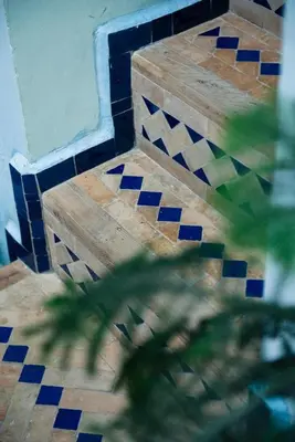 a bathroom with a tiled floor and a wall at dar annee in Fès