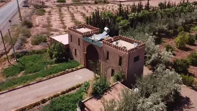 an aerial view of a building in the middle of a field at oasis des collines