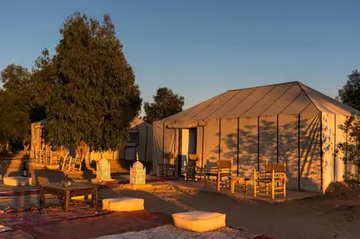 a tent with tables and chairs in front of it at Sindibad Desert Camp in Merzouga