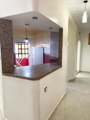 a kitchen with a counter top in a room at Grand appartement familial - Calme & bien situé à Mèknes in Meknès