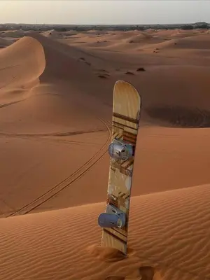 a snowboard in the sand in the desert at Merzouga Hous in Merzouga