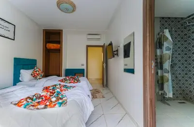 a bedroom with a bed with a blanket on it at Villa de Luxe à Marrakech avec Piscine Chauffée Privée in Aghmat