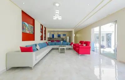 a living room with a couch and red chairs at Villa de Luxe à Marrakech avec Piscine Chauffée Privée in Aghmat