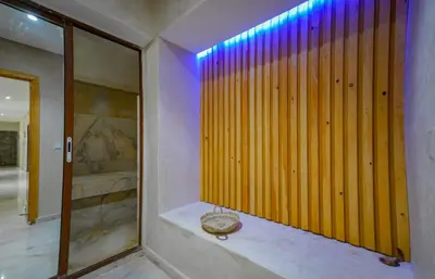 a bathroom with a wooden wall and a mirror at Villa de Luxe à Marrakech avec Piscine Chauffée Privée in Aghmat
