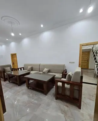 a living room with couches and tables in a room at Riad Gogo in Aït Ben Haddou
