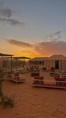 a group of tents in the desert at sunset at Desert luxury in Hassilabied
