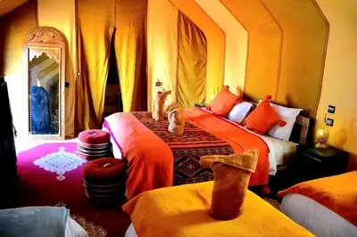 a bedroom with two beds and a mirror at Desert luxury in Merzouga