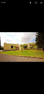 a view of a building and a field of grass at Villa athis in Fourou